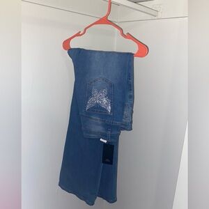 Hi! Slightly ripped blue jeans. Butterfly embroidery on back pockets.